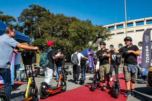 Pessoas testam patinetes elétricos em praça em frente ao estádio do Pacaembu em 2022