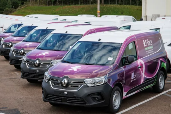 Veículos Renault Kangoo E-Tech com adesivos da Vivo perfilados em estacionamento